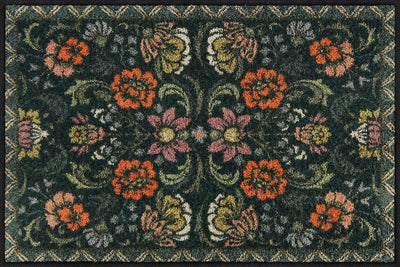 Salonloewe Fußmatte mit symmetrischem Blumenmuster auf dunkelgrünem Hintergrund